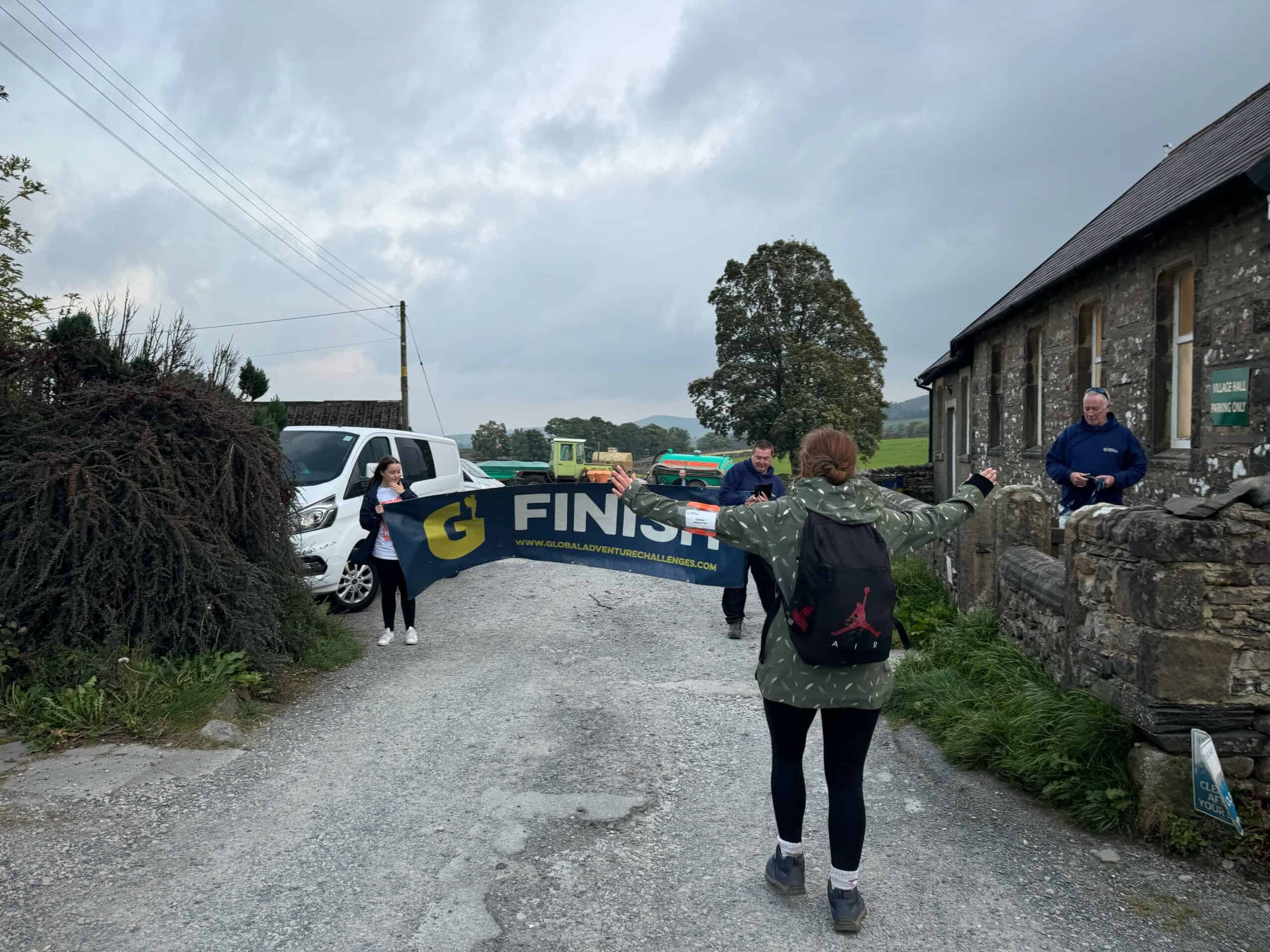 Gemma Midleton crossing the Care Workers' Charity Yorkshire 3 Peaks Finish line